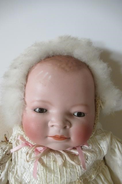 A bisque head flange neck baby doll Image