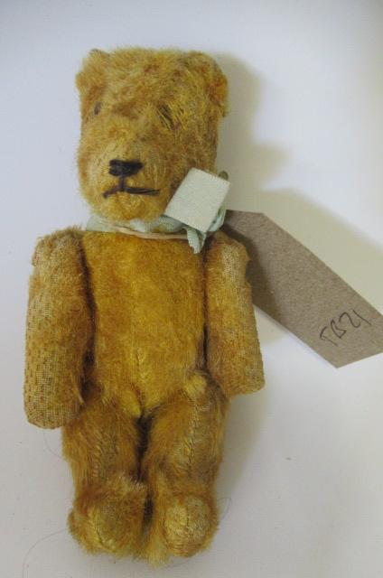 A miniature straw filled teddy Image