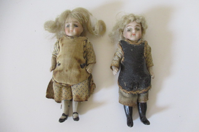 A pair of all bisque doll's house dolls Image