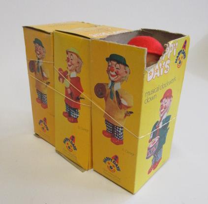 Three Eisenmann clockwork clowns in plastic and tin boxes Image