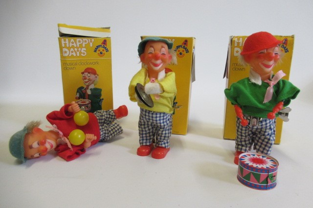 Three Eisenmann clockwork clowns in plastic and tin boxes Image