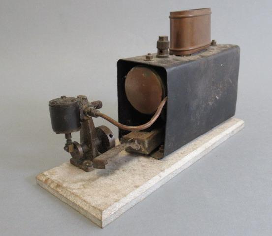 Small Marine type spirit fired engine with single oscillating cylinder on wooden base Image