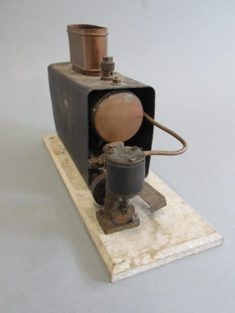Small Marine type spirit fired engine with single oscillating cylinder on wooden base Image