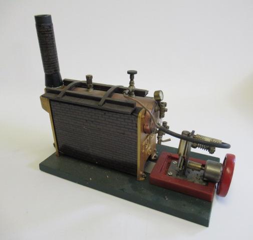 Single cylinder stationary steam engine with Stuart turner boiler and spirit burner with scratch Image