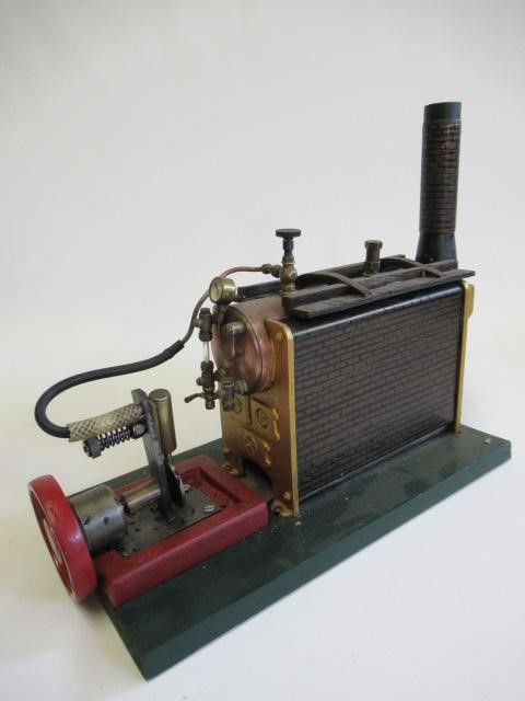 Single cylinder stationary steam engine with Stuart turner boiler and spirit burner with scratch Image