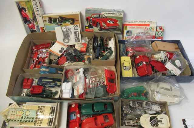 A large quantity of spare parts for 1:32 slot car racing including chassis Image