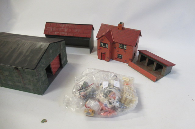 Three wooden farm buildings with a small quantity of plastic farm animals Image