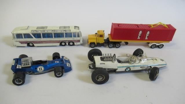 Unboxed diecast vehicles including Schuco BMW race car and Dinky luxury bus Image