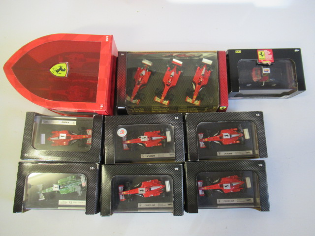 Nine Hot Wheels 1:48 racing cars including F1 Ferraris Image