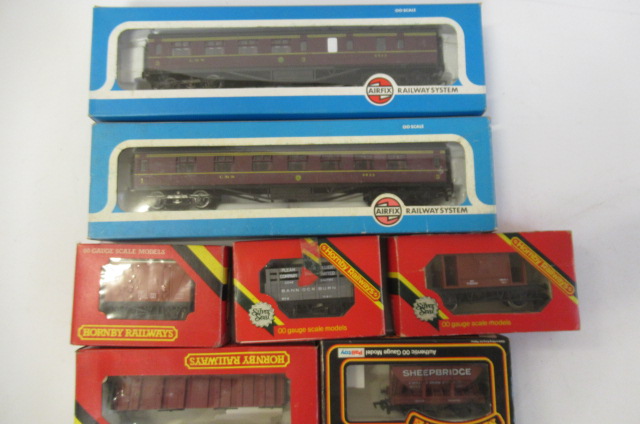 Rolling stock by Airfix and Hornby comprising five goods trucks and two L.M.S. coaches Image
