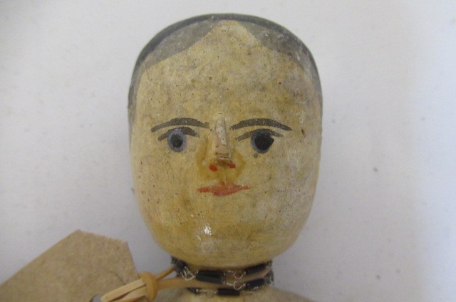 An antique peg doll Image