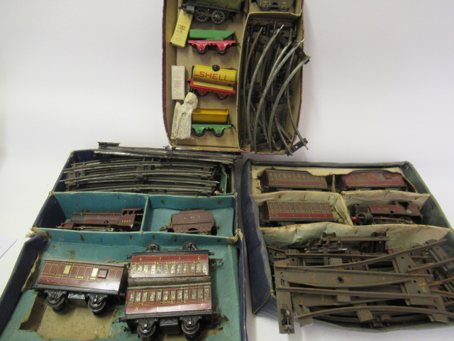 Three playworn Hornby clockwork train sets comprising 201 Goods Set Image