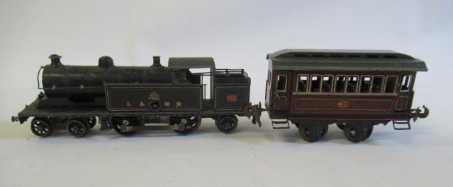 Bassett-Lowke clockwork 4-4-2 L.N.W.R. tank and Garrett gauge 1 four wheel coach in red opening roof Image