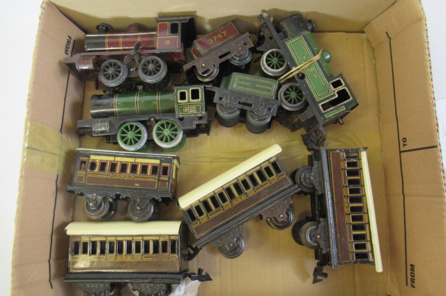 Three Bing clockwork locomotives and four G.W.R. four wheel coaches Image