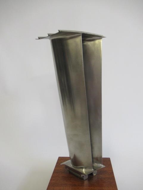 Two turbine blades from a Rolls Royce gas turbine engine mounted on wooden base with retirement Image