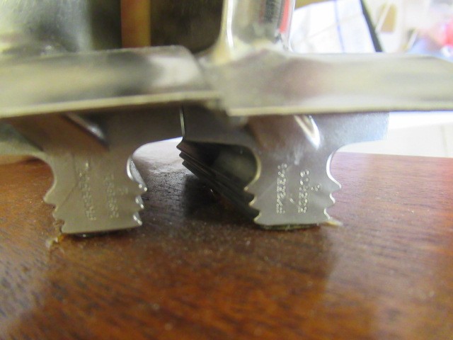 Two turbine blades from a Rolls Royce gas turbine engine mounted on wooden base with retirement Image