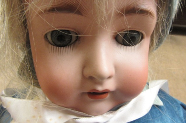 A German bisque socket head doll with blue glass sleeping eyes Image