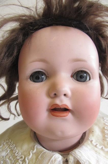 A Melitta bisque socket head doll with blue glass sleeping eyes Image