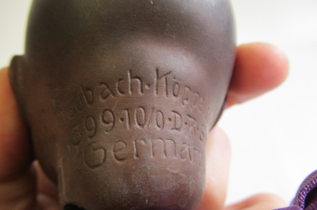 A Heubach bisque socket head mulatto baby doll Image