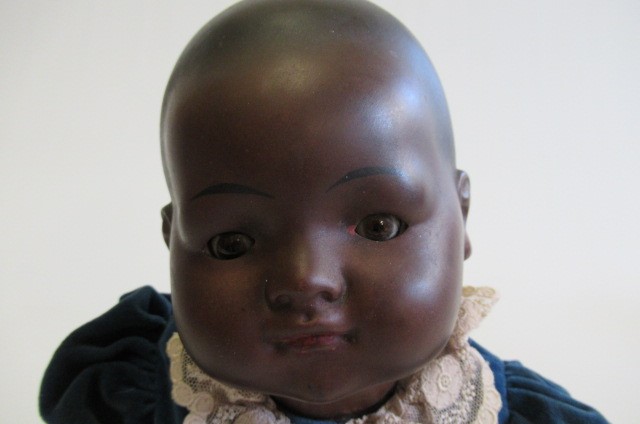 A bisque socket head mulatto baby doll Image