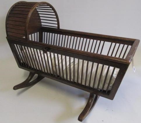 A doll's painted wood cradle Image
