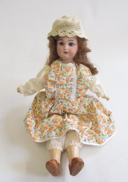 A French bisque socket head walking doll with blue glass fixed eyes Image