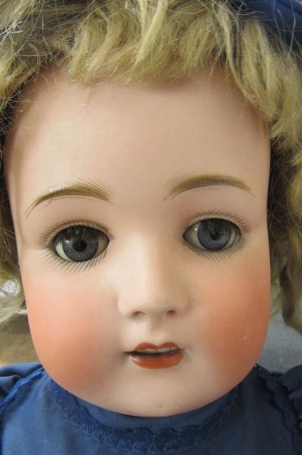 A Kestner bisque socket head doll with blue glass sleeping eyes Image