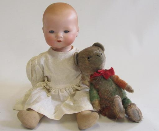 An Armand Marseille bisque flange neck baby doll with blue glass sleeping eyes Image