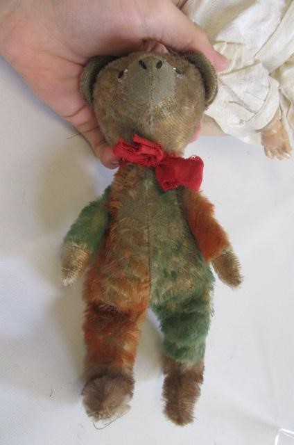 An Armand Marseille bisque flange neck baby doll with blue glass sleeping eyes Image