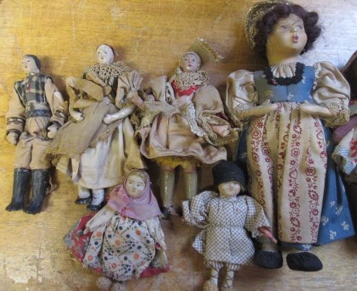 A collection of fourteen national costume and other small dolls including a Victorian German bisque Image