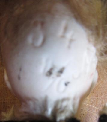 A collection of fourteen national costume and other small dolls including a Victorian German bisque Image