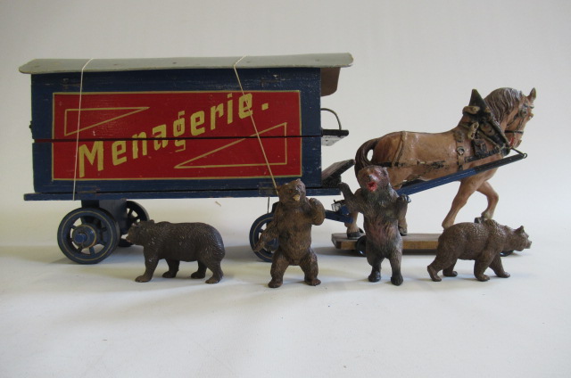 A large wooden horse drawn wagon finished in blue and red with Managerre to side with a large Image