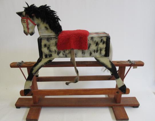 A scratch built rocking horse of painted wood construction Image