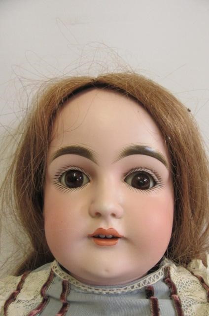 A Kestner bisque socket head doll with brown glass sleeping eyes Image