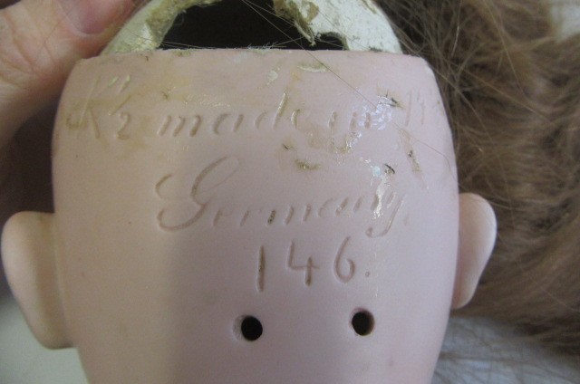 A Kestner bisque socket head doll with brown glass sleeping eyes Image