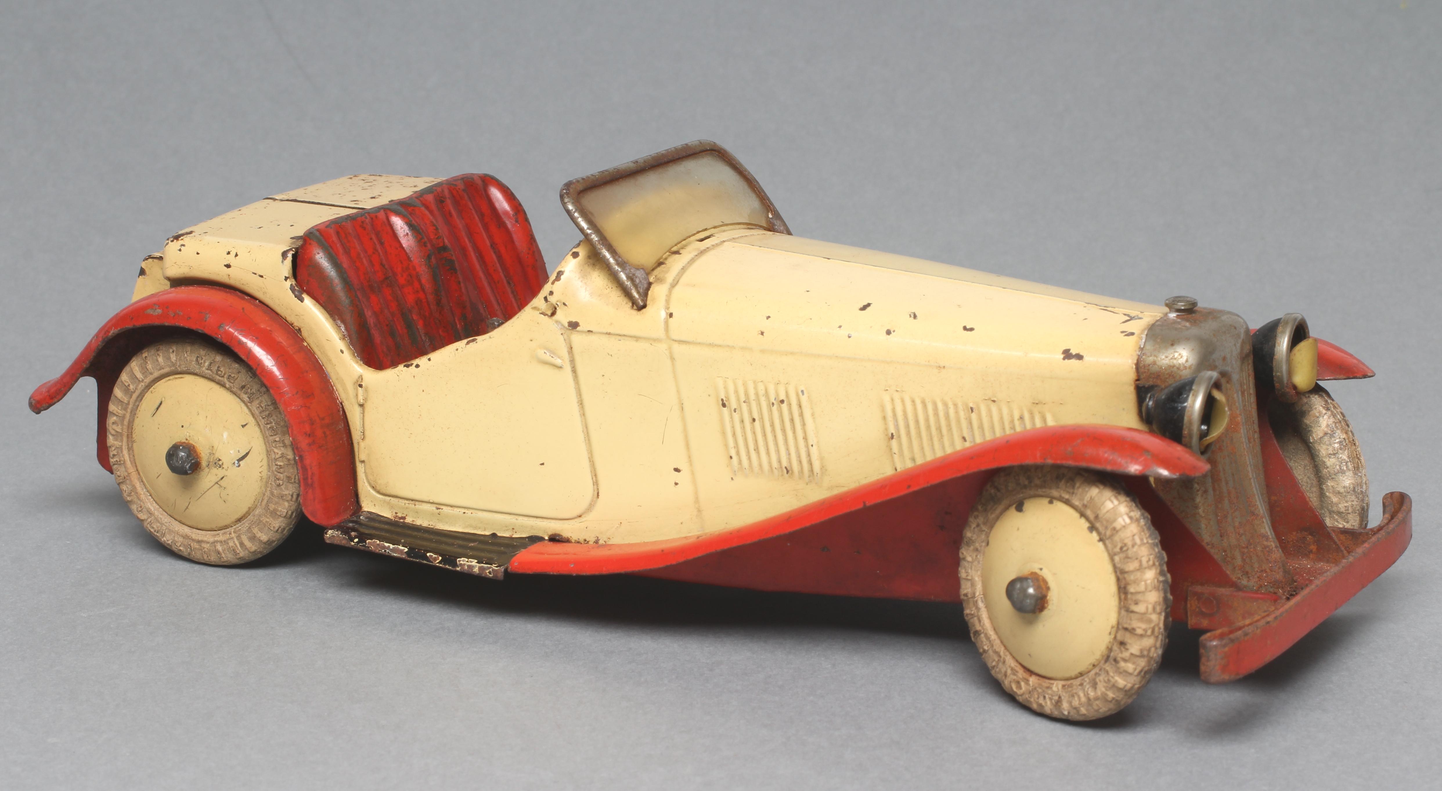 Meccano clockwork sports car finished in red and cream Image
