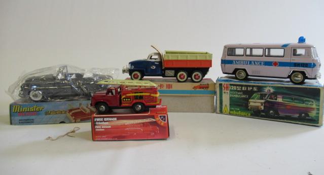 Four friction powered vehicles comprising ten wheel truck Image