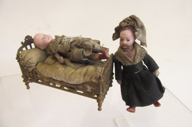 A pair of French all bisque dolls house dolls Image