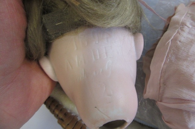 An Armand Marseille 1894 bisque socket head doll Image
