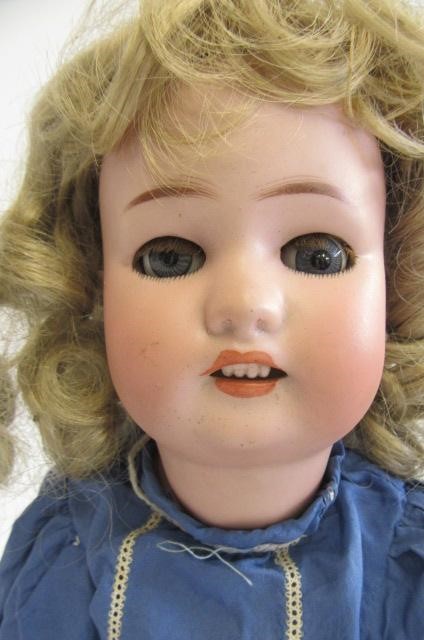 A Simon & Halbig bisque socket head doll with blue glass sleeping eyes Image