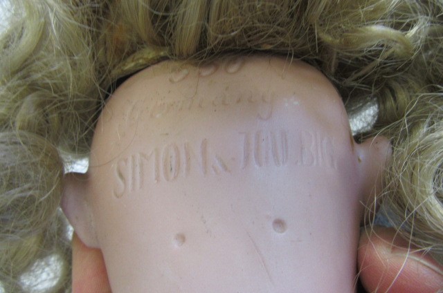 A Simon & Halbig bisque socket head doll with blue glass sleeping eyes Image