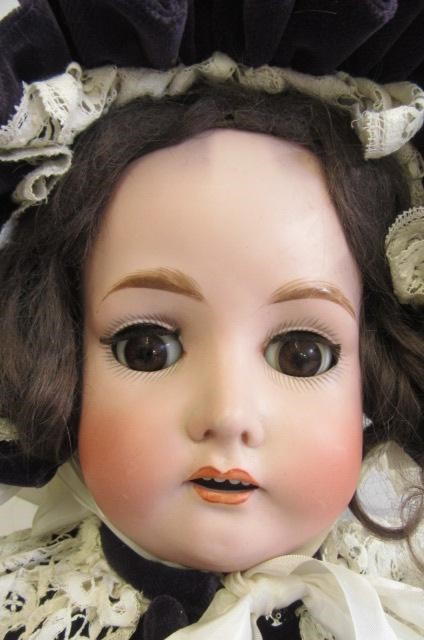 A Kestner bisque socket head doll with brown glass sleeping eyes Image
