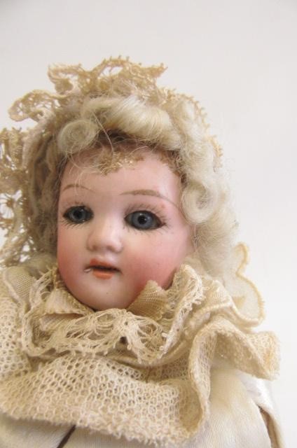 A Schoenau & Hoffmeister bisque head Marotte doll with blue glass eyes Image