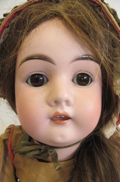 A Max Handwerck bisque socket head doll with brown glass sleeping eyes Image