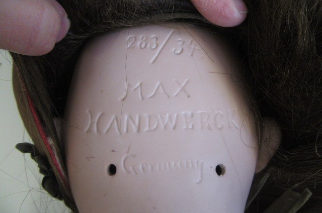 A Max Handwerck bisque socket head doll with brown glass sleeping eyes Image