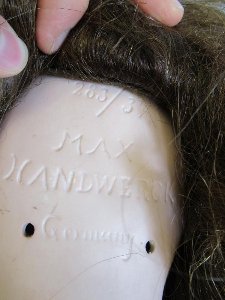 A Max Handwerck bisque socket head doll with brown glass sleeping eyes Image