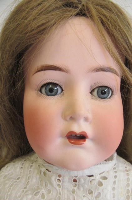 A Cuno & Otto Dressel bisque socket head doll with blue glass sleeping eyes Image
