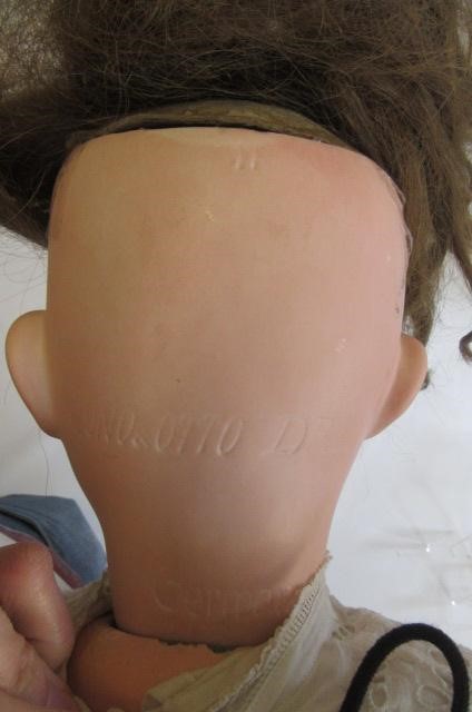 A Cuno & Otto Dressel bisque socket head doll with blue glass sleeping eyes Image