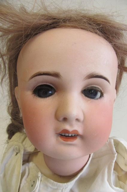 An S.F.B.J. bisque socket head doll with blue glass eyes Image