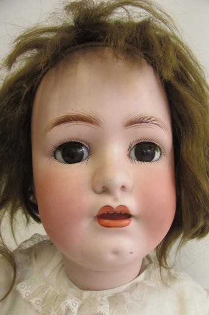 A Franz Schmidt & Co. bisque socket head doll with brown glass sleeping eyes Image